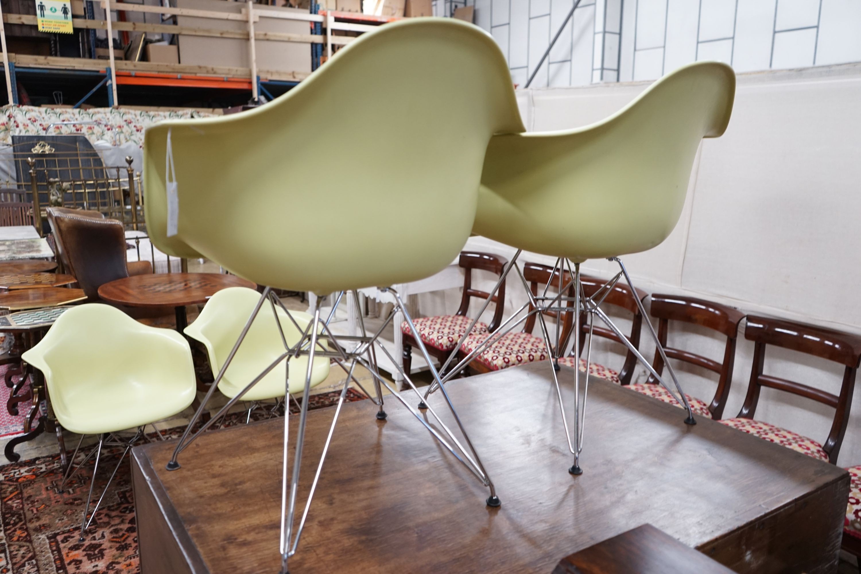 A set of four Eames Vitra aluminium and polycarbonate chairs, width 62cm, depth 48cm, height 80cm